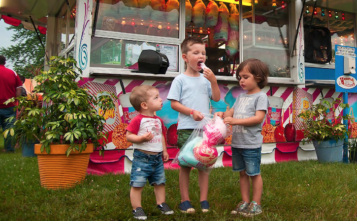 Three kids at a carnival