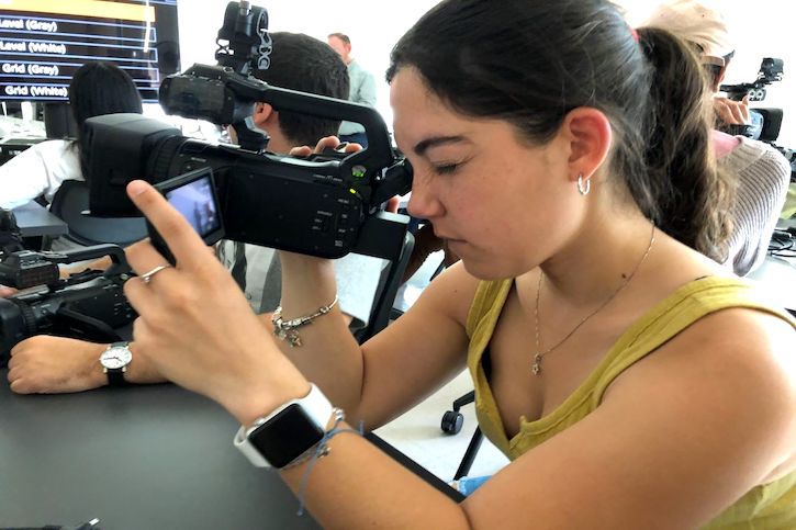 Student holding video camera