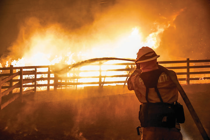 Fireman attempting to tame a wild fire 